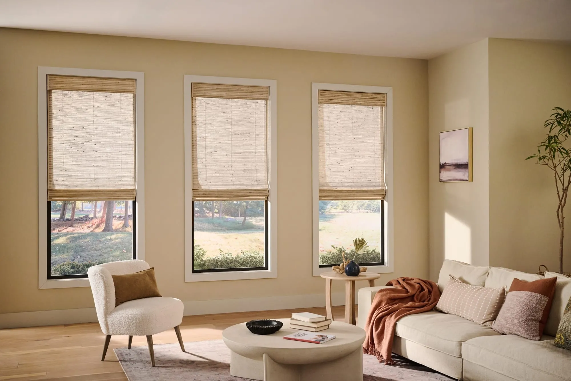 Alta natural woven shades on three windows in a warm living room