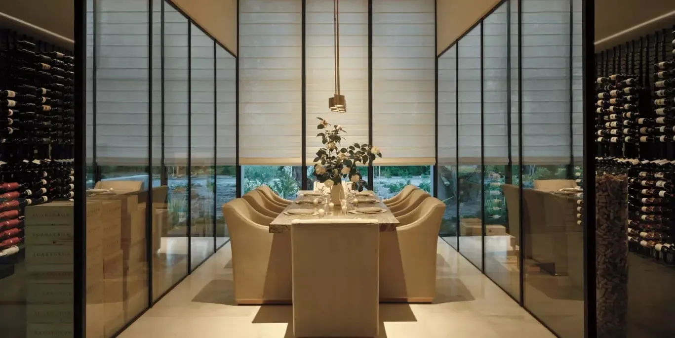 Alustra Woven Textures roller shades behind a dining table