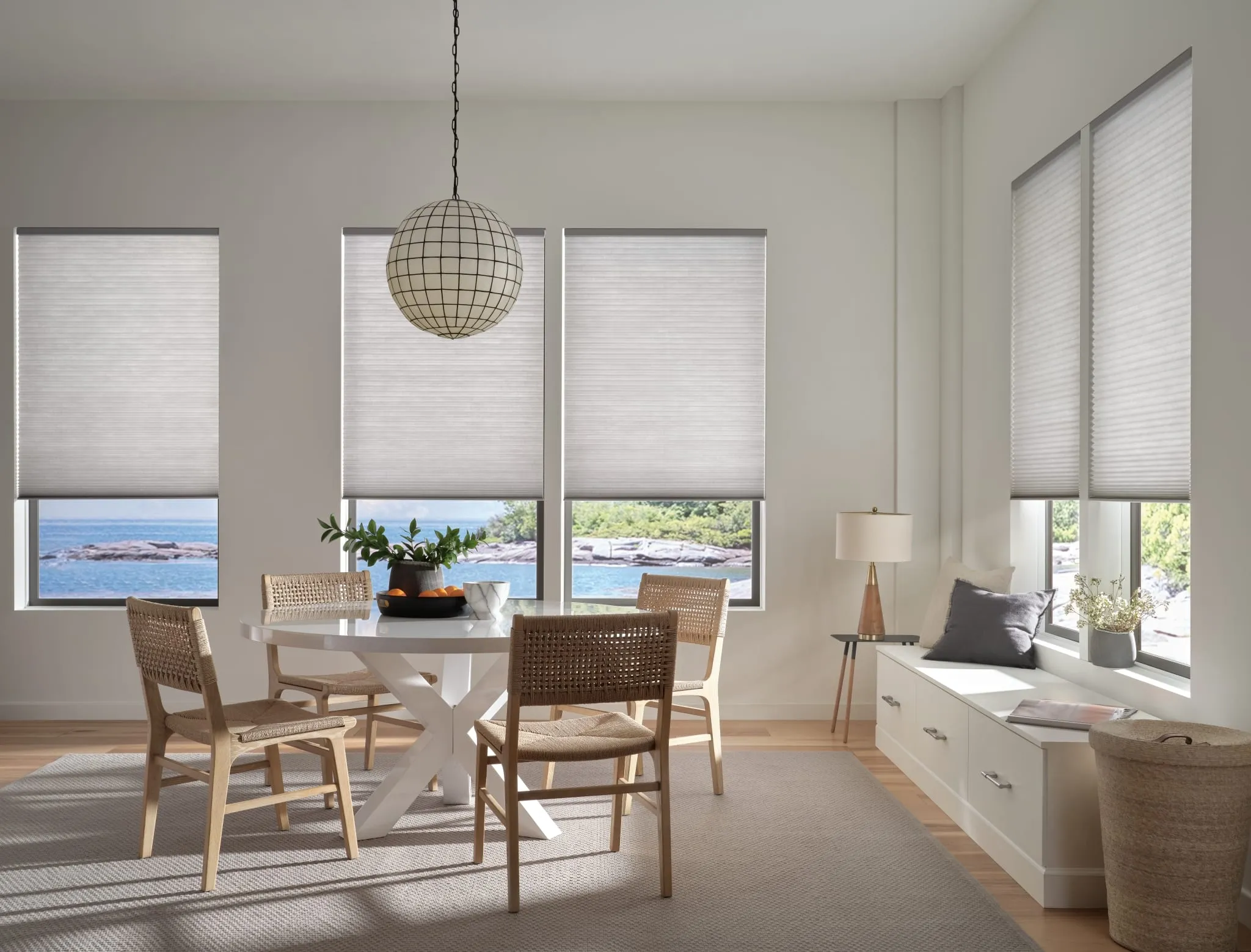 Applause® honeycomb shades in a dining room overlooking the water