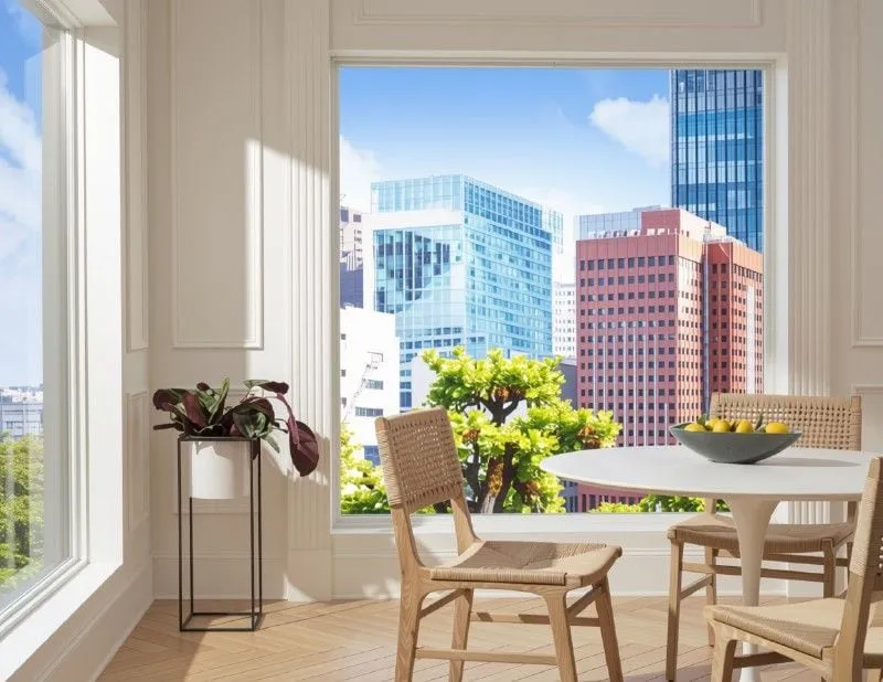 Dining nook with a city-view window before window treatments
