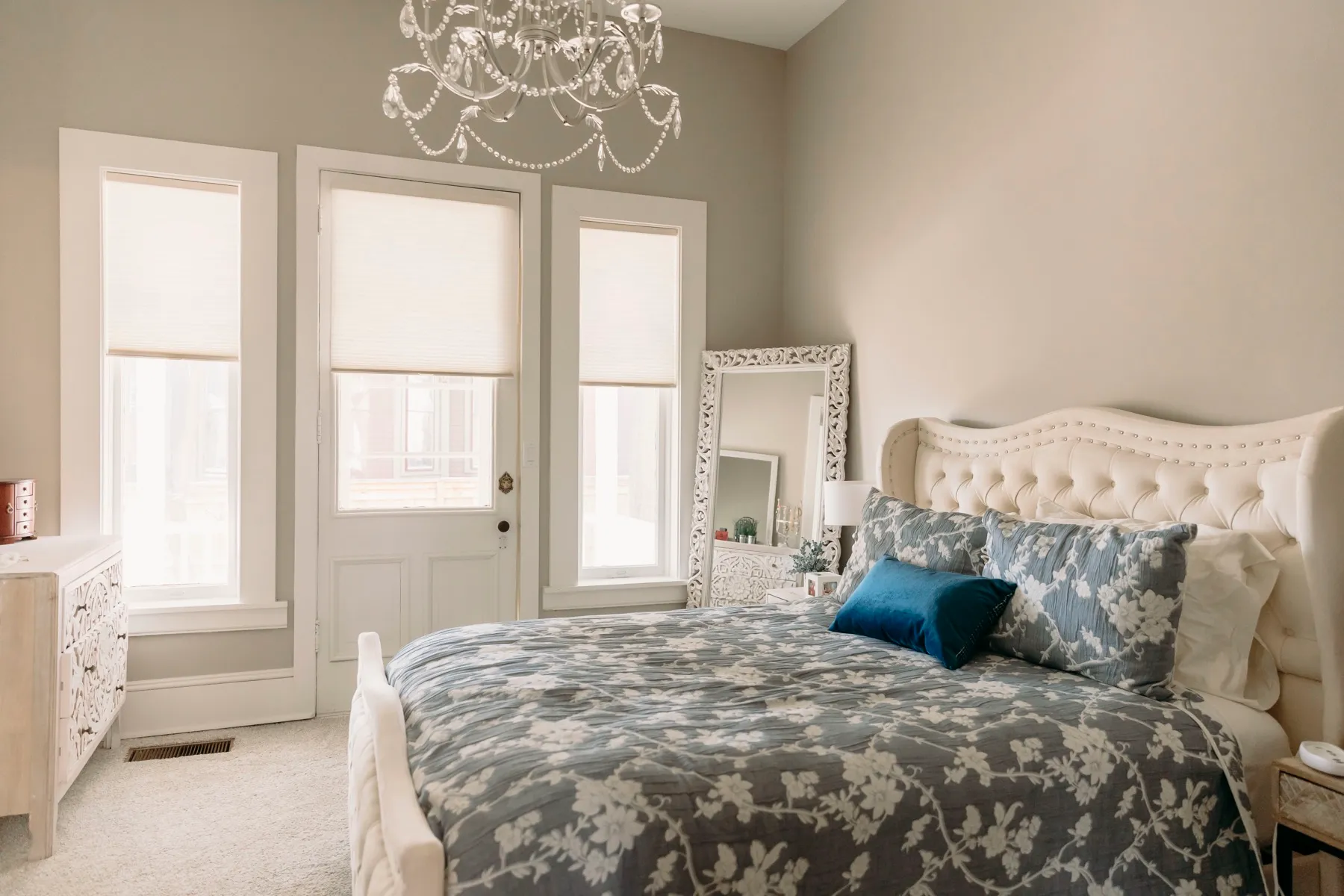 Bedroom with light-filtering cellular shades on three windows