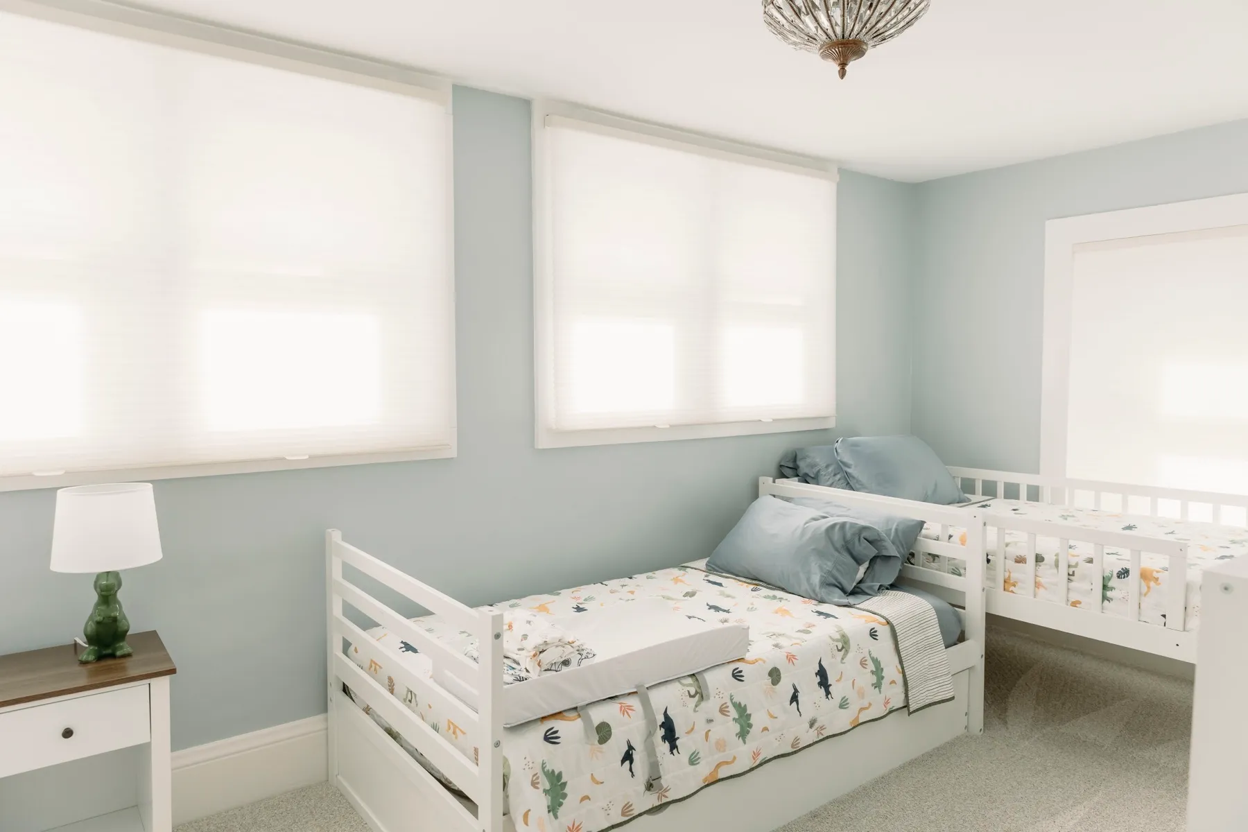 Kids' room with cellular shades on two windows