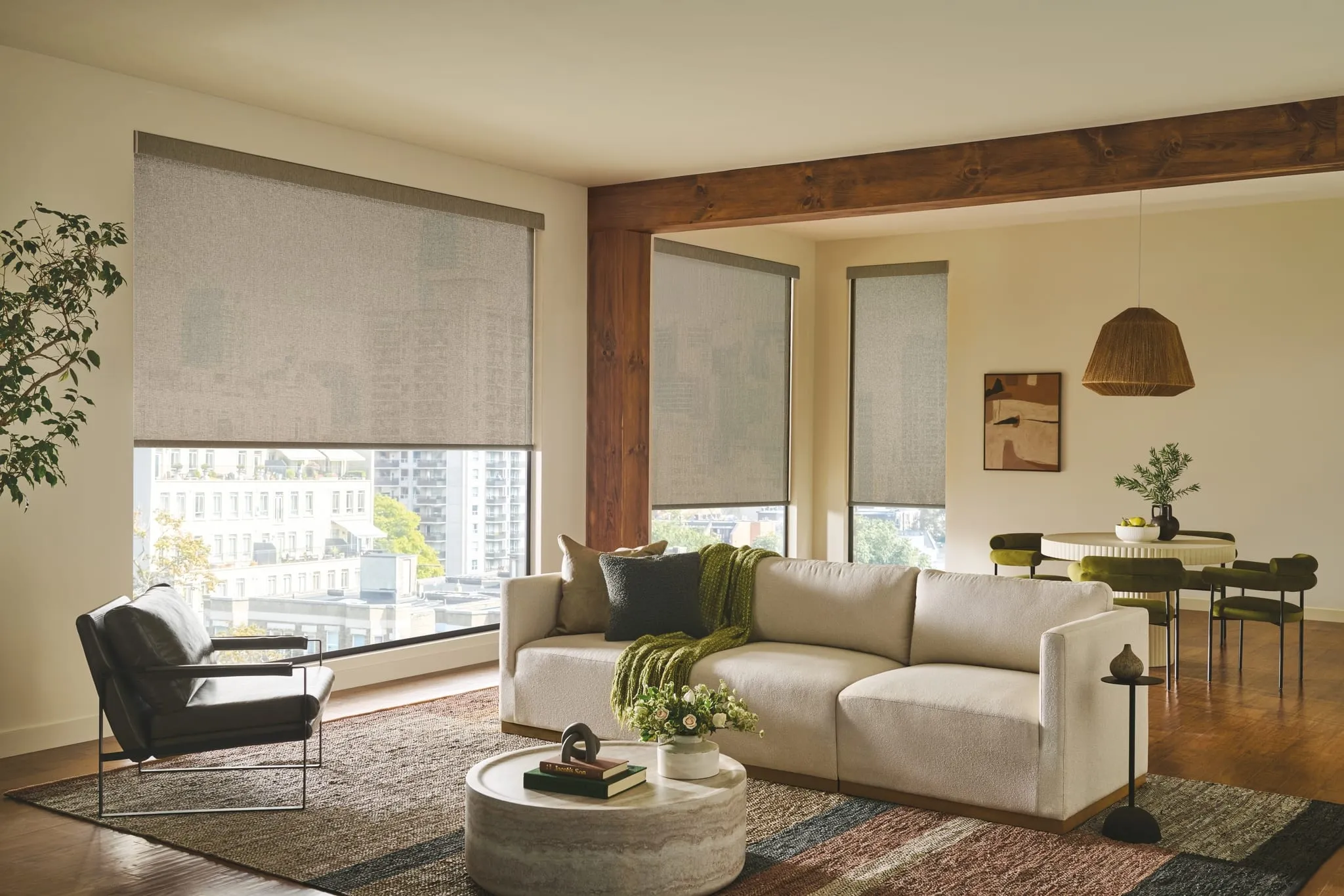 Designer roller shades in a living room with city views