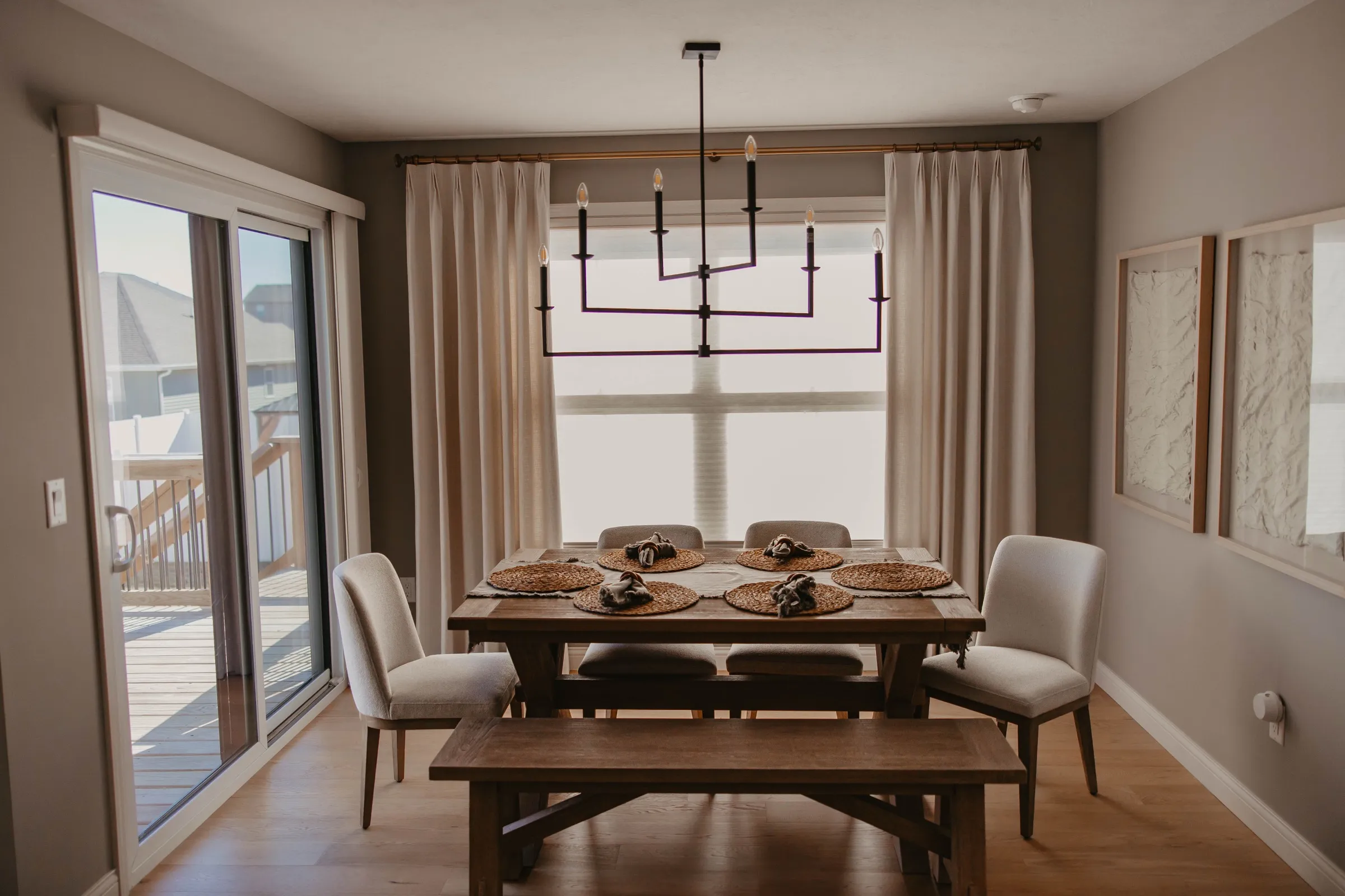 Dining room with custom drapery panels over shades