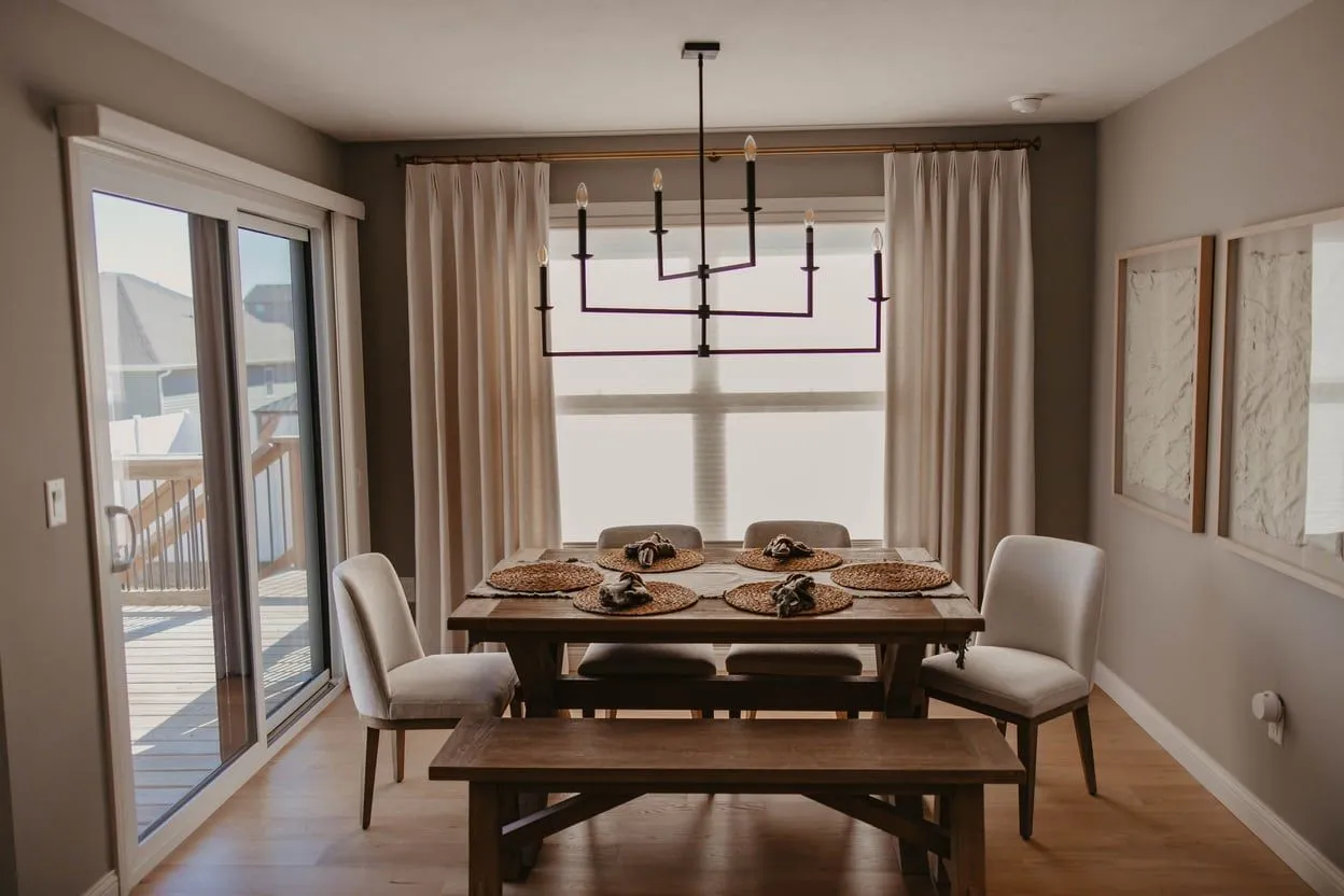 The same dining room with custom drapery panels framing the window