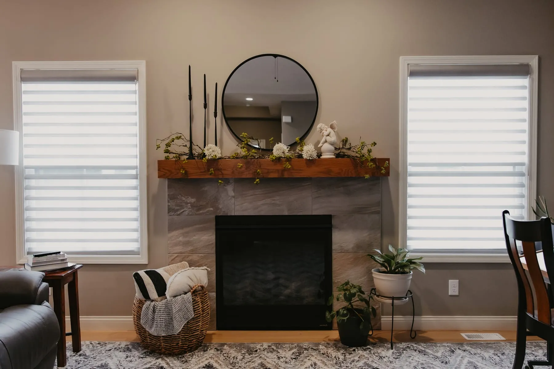 Sheer shades on the windows on either side of a fireplace
