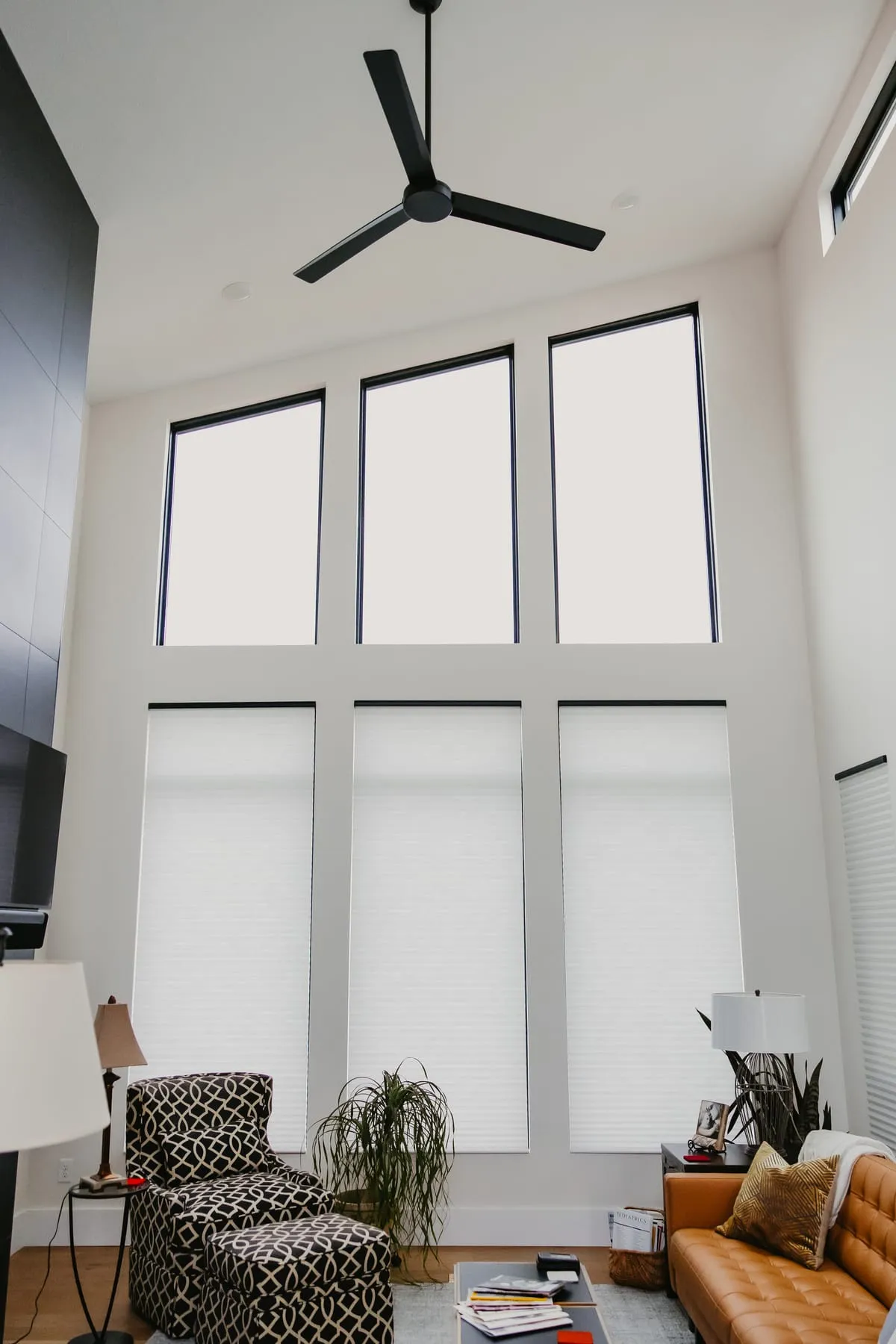 Two-story living room with shades on every window