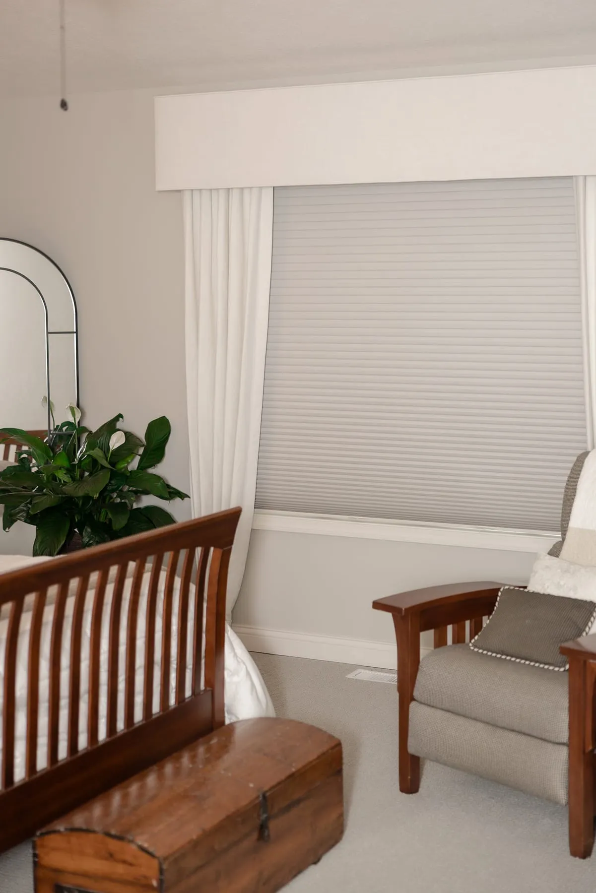 Window with a fabric valance above a wooden bench