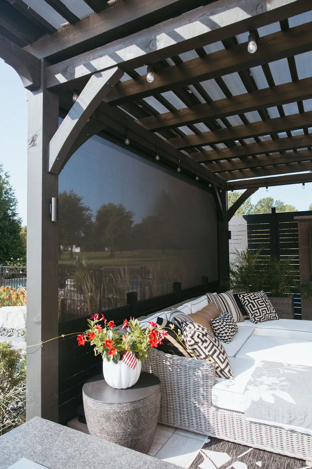 Inside the pergola with a screen lowered for shade