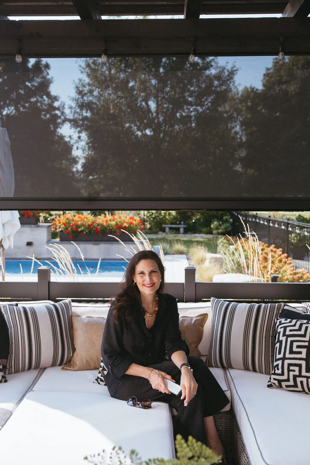 Relaxing under the pergola with a solar screen lowered
