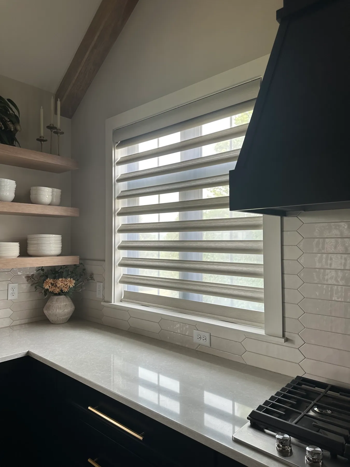 Kitchen window with a Pirouette® shade above open shelving