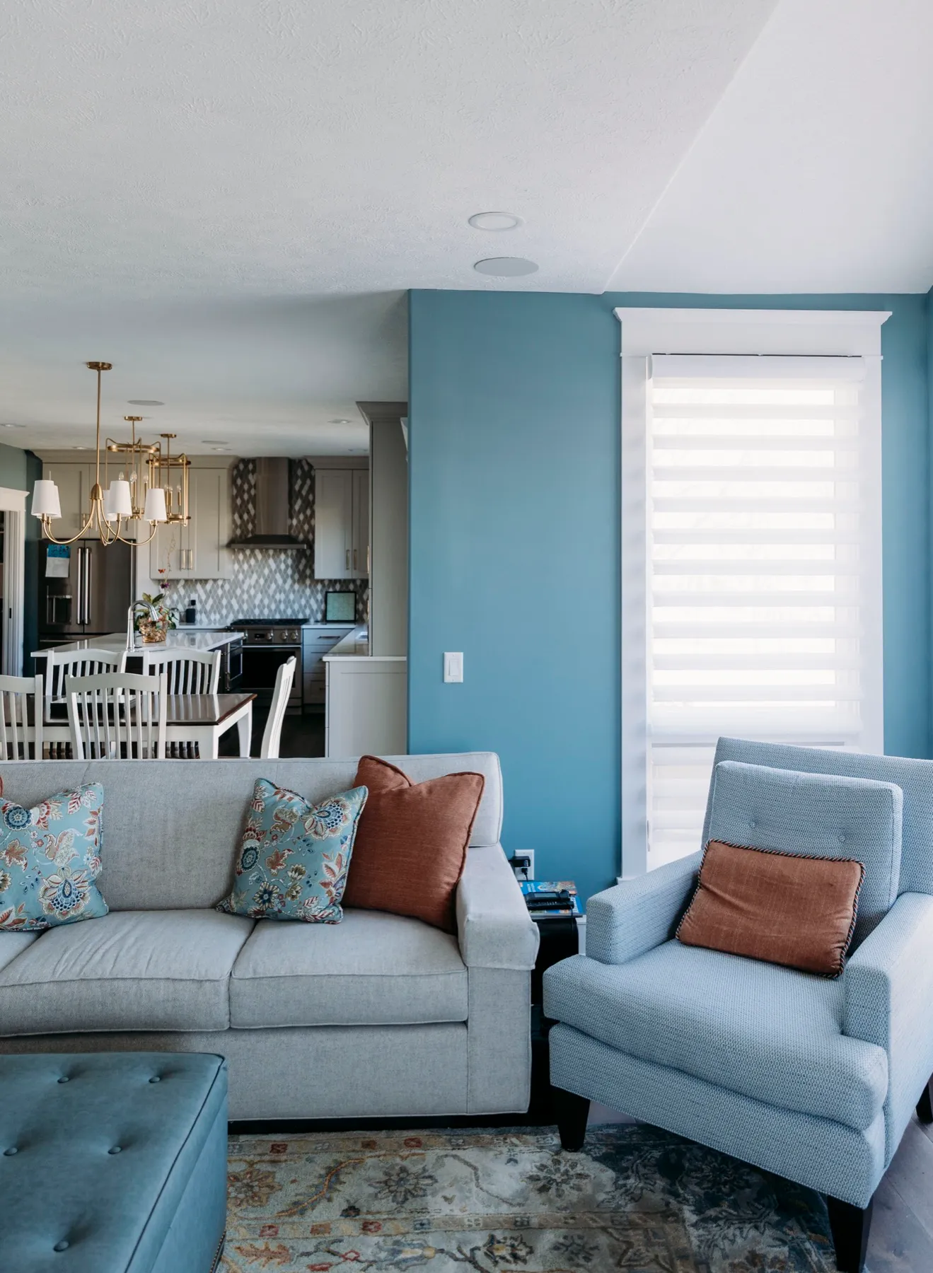 Living room with motorized shades on the corner windows
