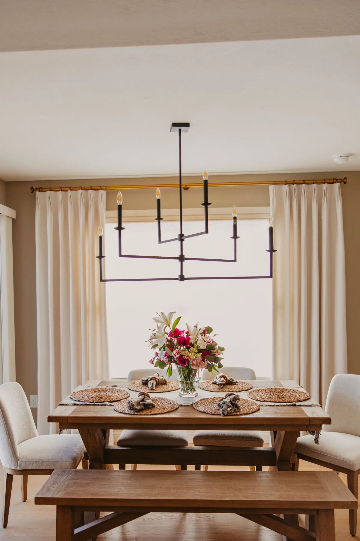 Dining room window dressed in full-length drapery panels