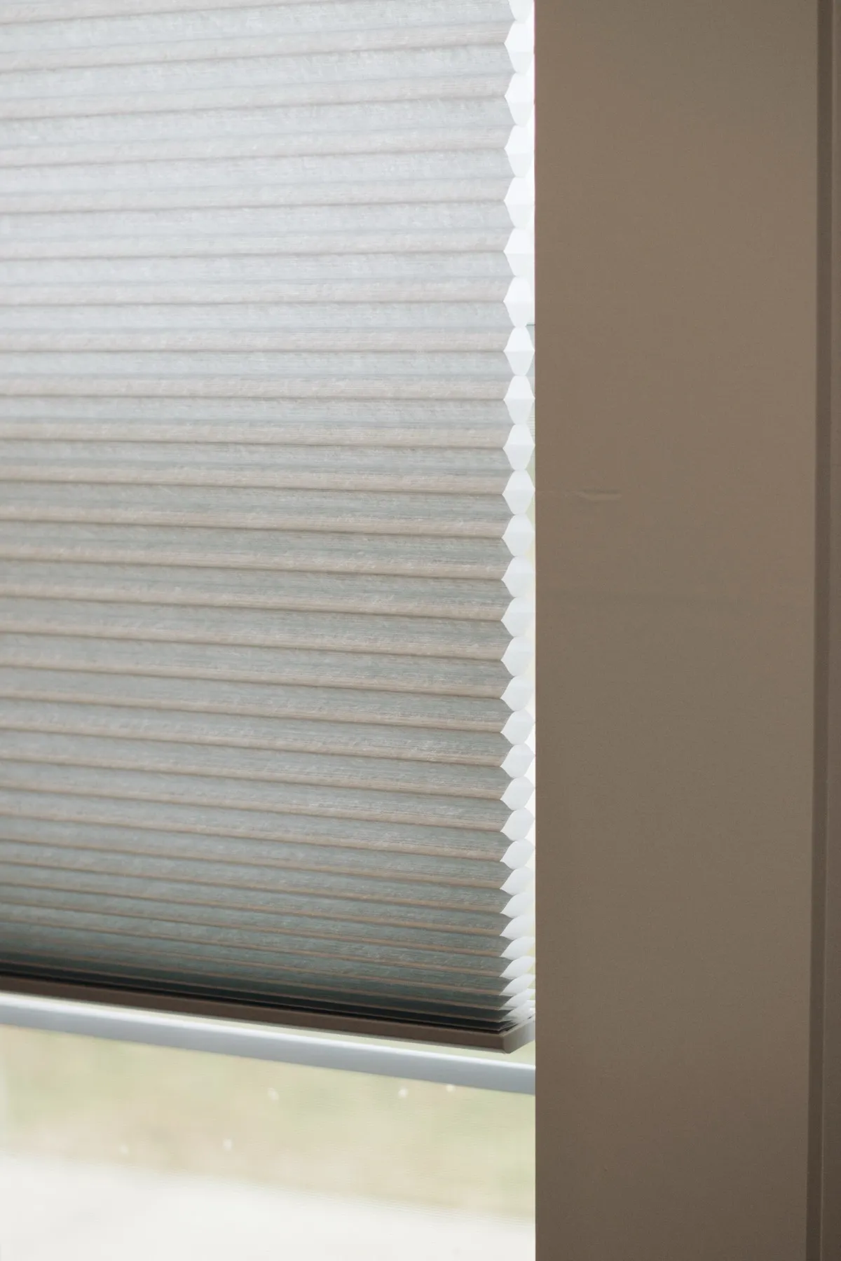 Cellular shade beside the window trim