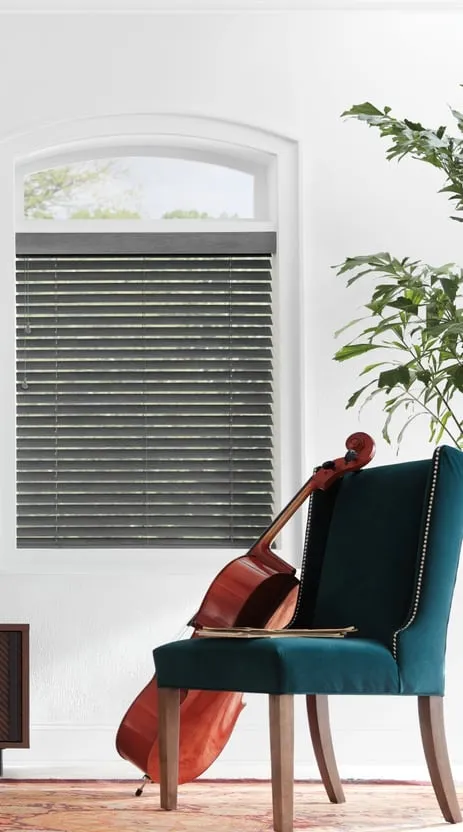 The same arched window with Parkland® wood blinds