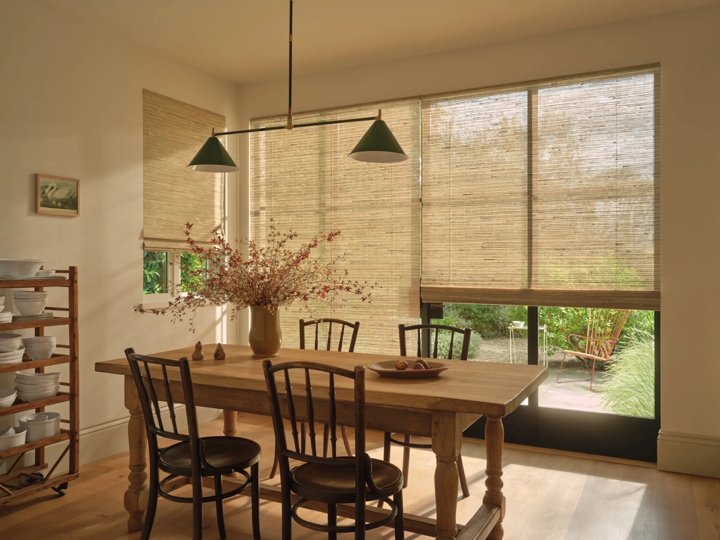 Provenance® Woven Wood Shades on dining room windows and a patio door