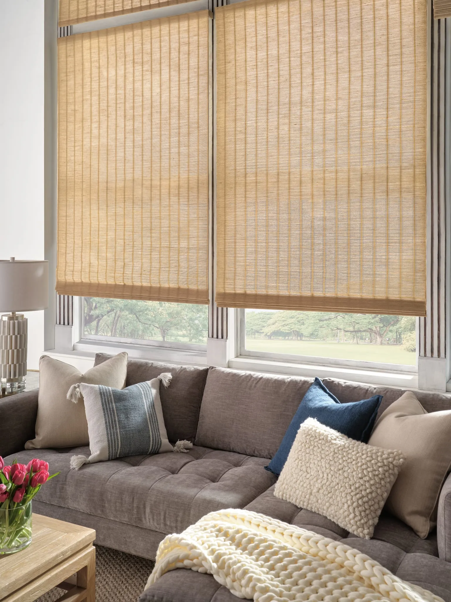 Provenance® woven wood shades above a living room sofa