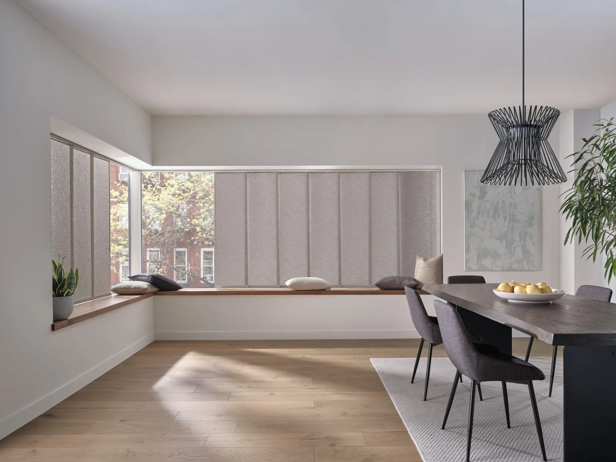 Skyline® gliding window panels across a wide dining room window