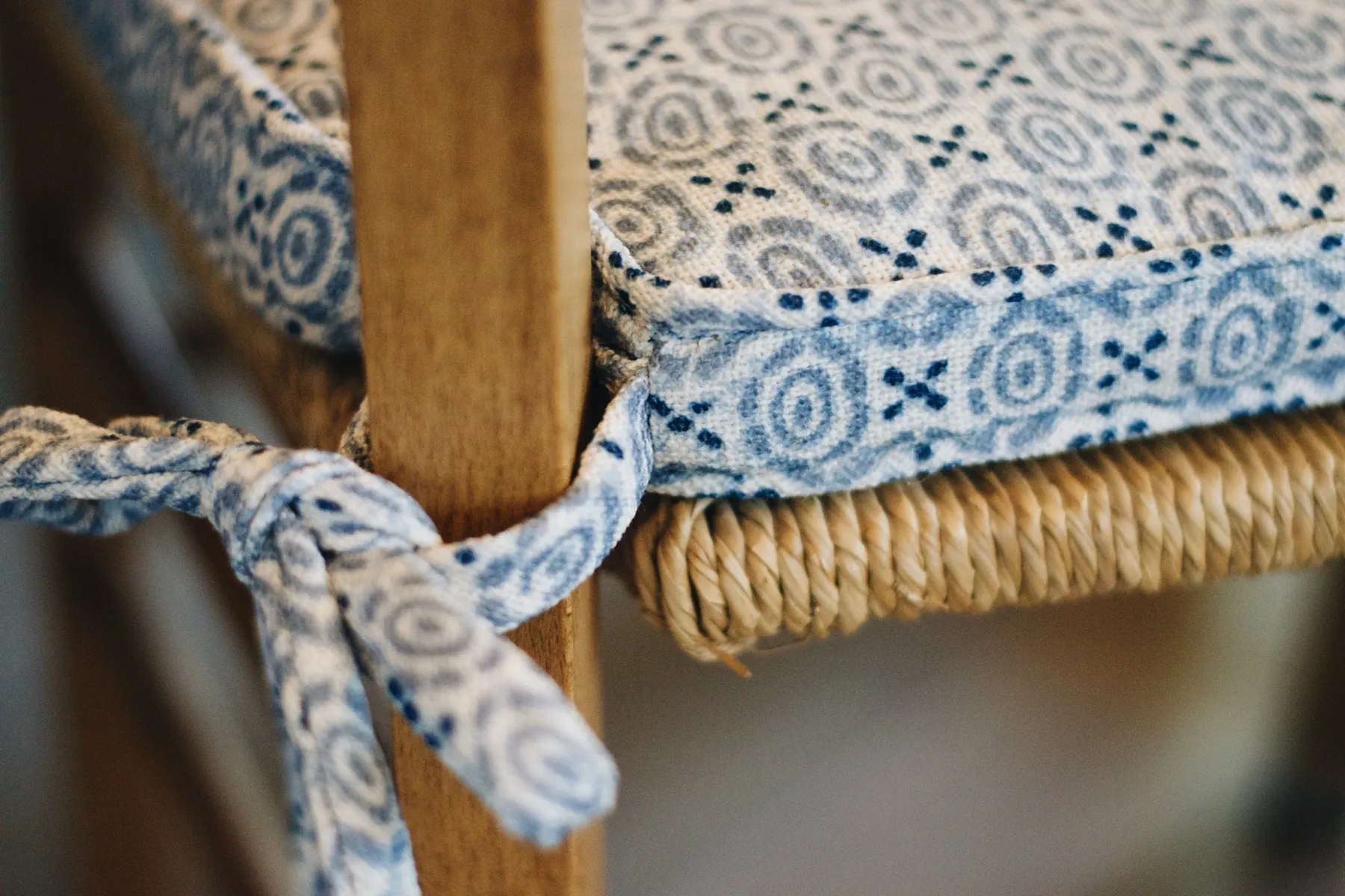 Custom seat cushion with ties on a rush chair